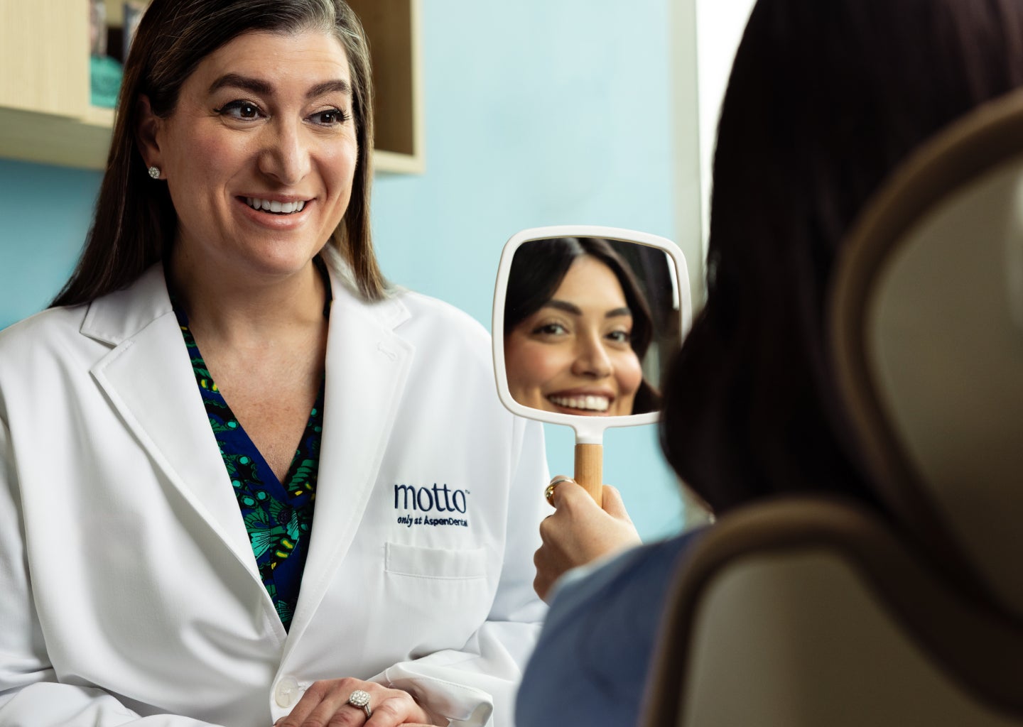 Doctor consulting with a patient about clear aligners, representing Motto FAQ guidance and in-person support