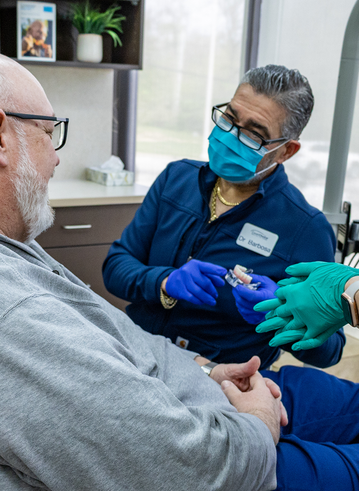 Snap-in dentures vs. permanent full arch implants: Which is right for you?