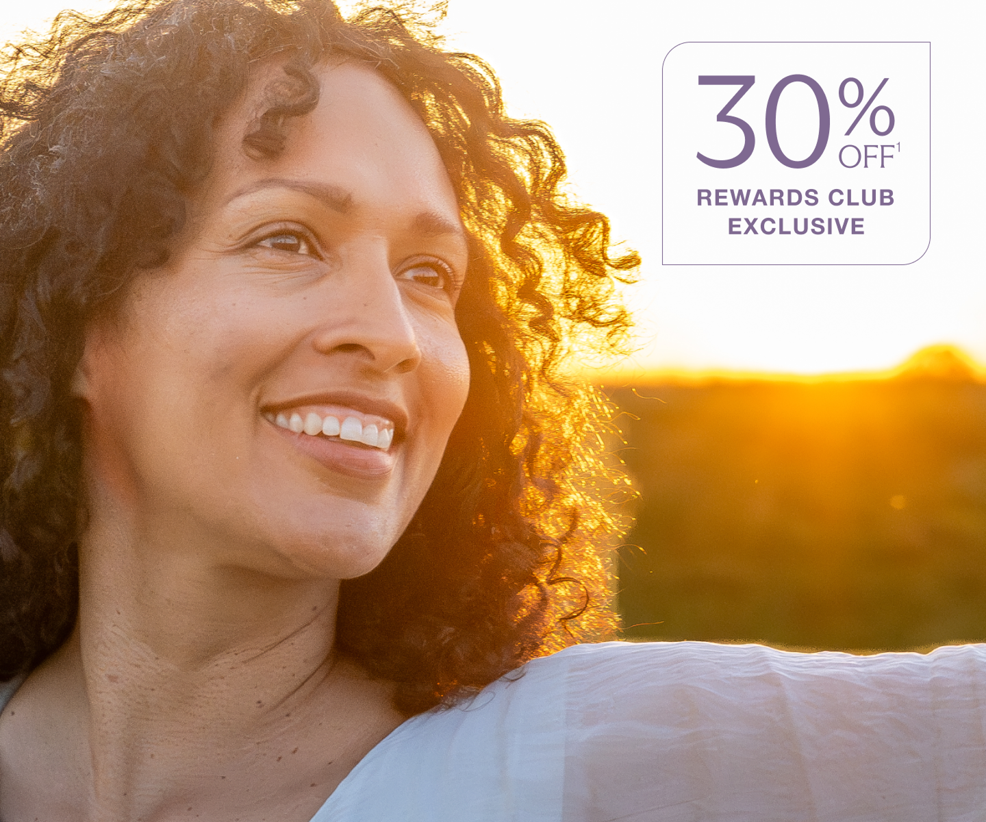 Smiling woman at sunset promoting Chapter Aesthetic Studio laser facial treatments with 30% off Rewards Club exclusive offer.