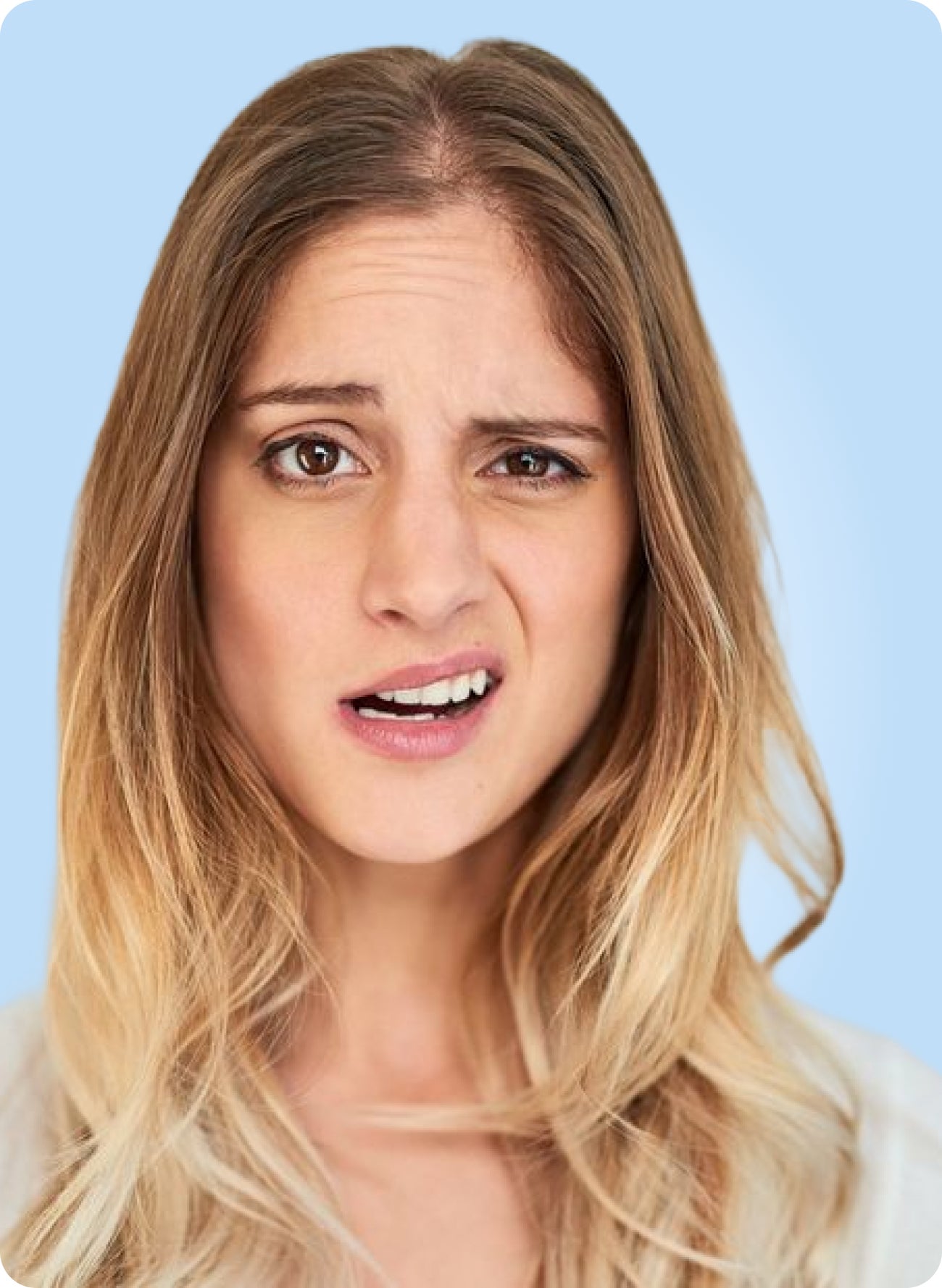 Concerned woman showing a visible gap between her front teeth, suggesting questions about a new space forming between teeth.