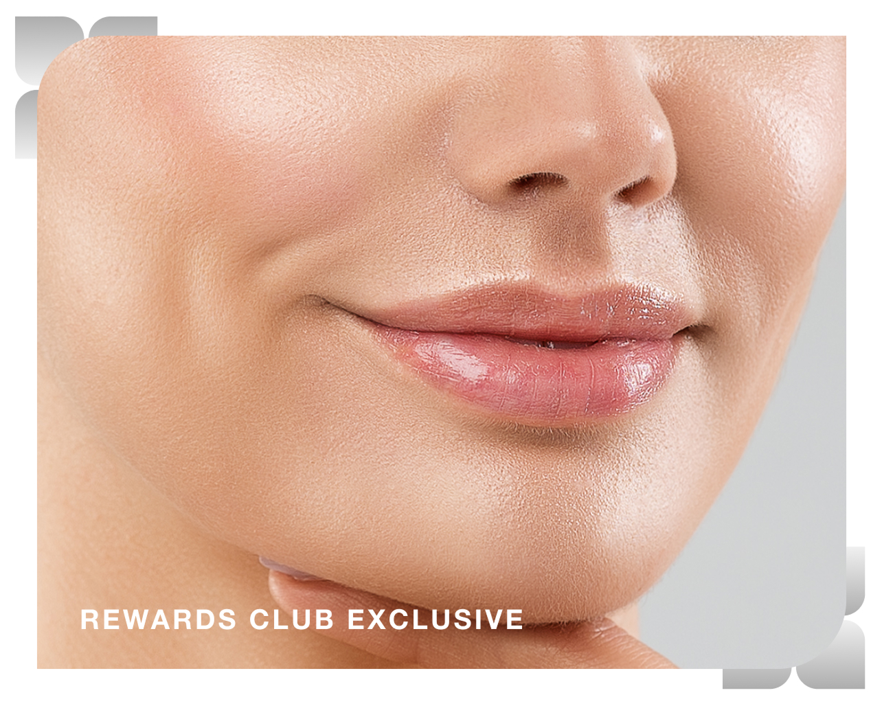 A closeup of a woman smiling after receiving treatment at Chapter, overlaid with text that reads "rewards club exclusive"