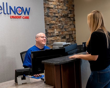 A WellNow Urgent Care team member greets a patient.