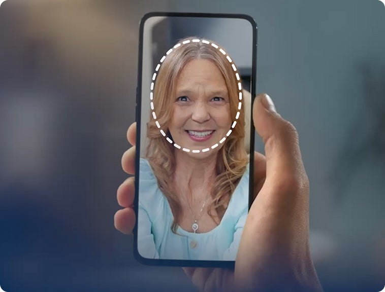A person is holding a cell phone with a woman 's face on it.