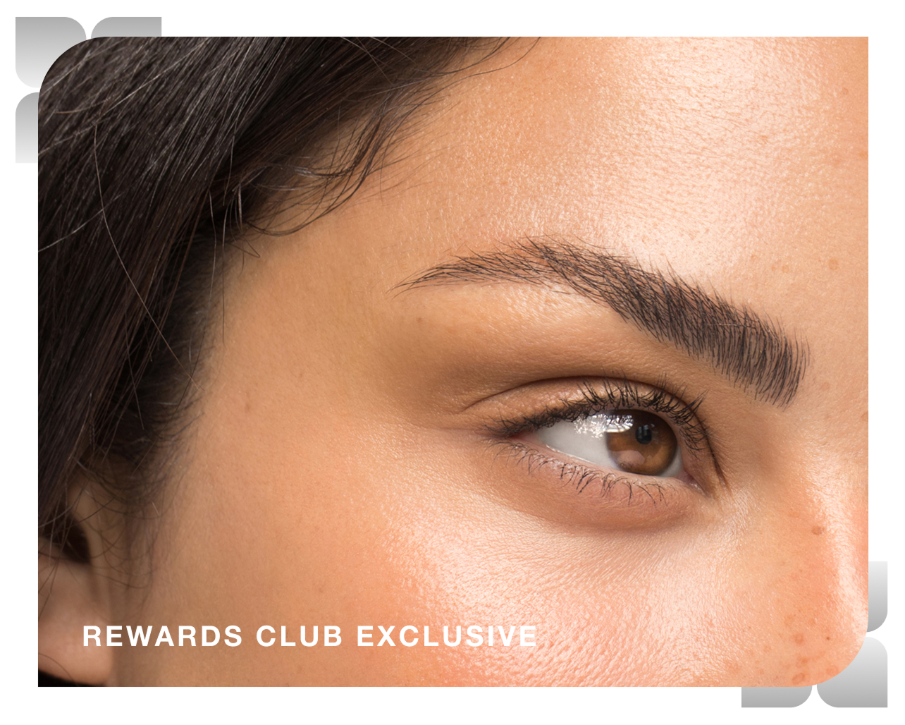 A closeup of a woman's eye and glowing cheek after receiving treatment at Chapter, with text overlaid which reads "Rewards club exclusive"