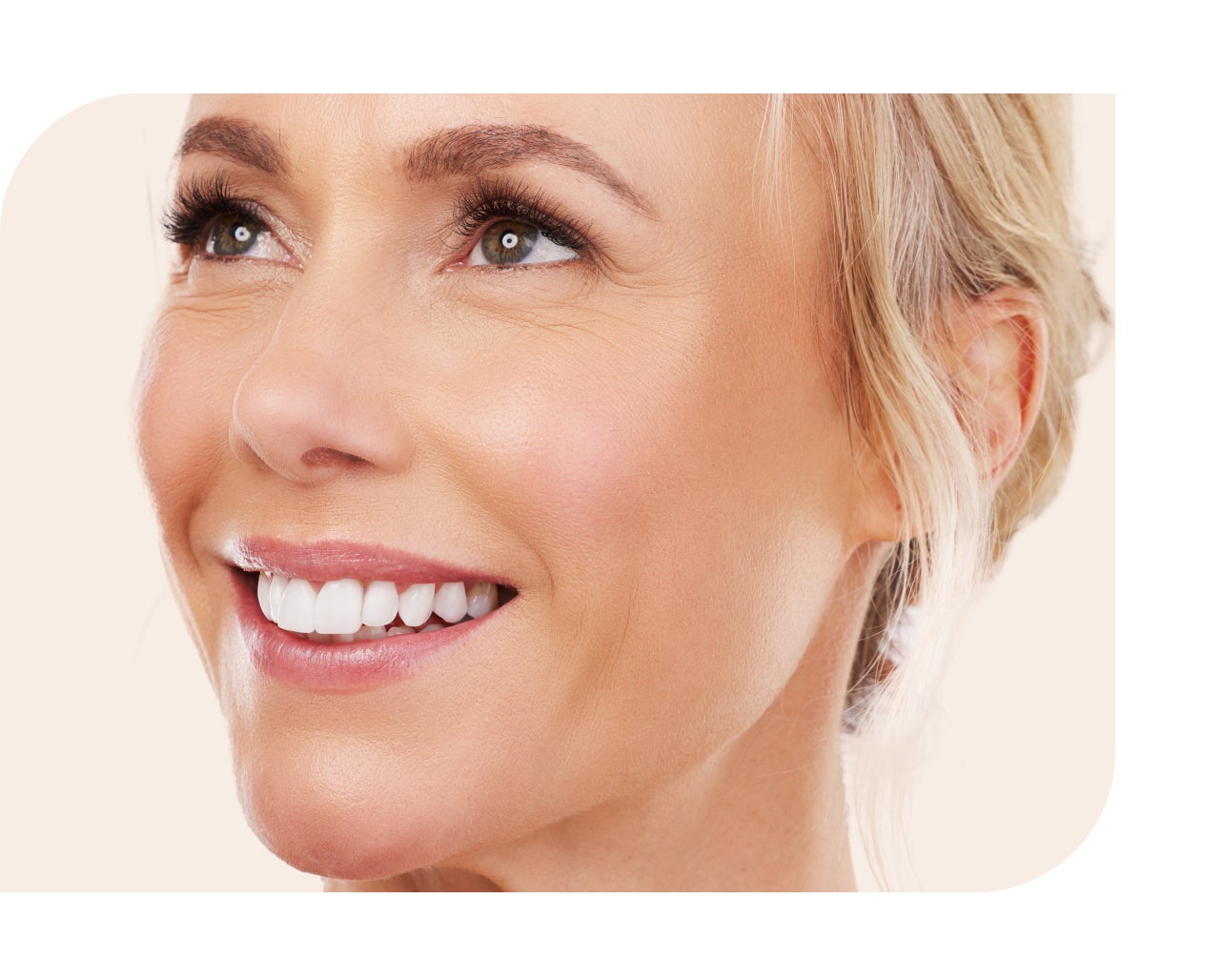 A radiant woman smiling and looking up