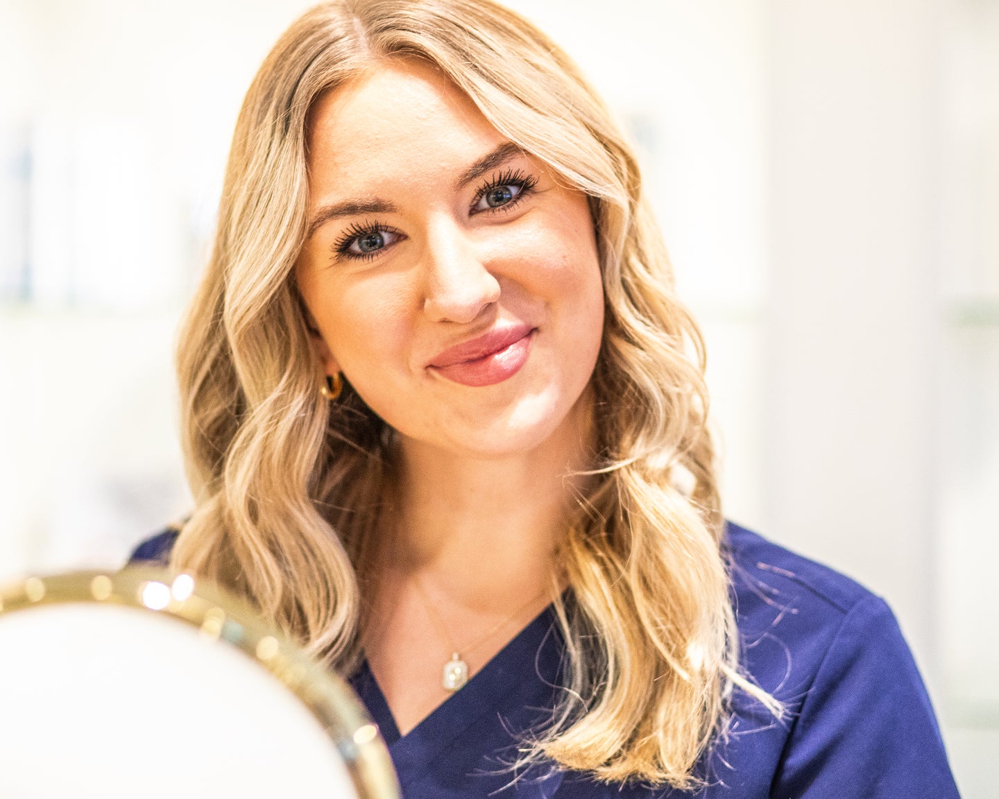 A Chapter aesthetic provider smiles confidently, representing expert filler care near you with trusted, natural-looking results.