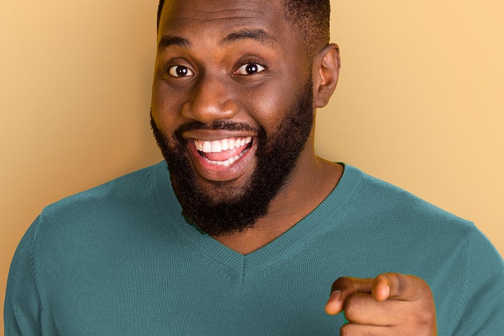 Smiling man highlighting insurance coverage and affordability for clear aligner treatment with Motto