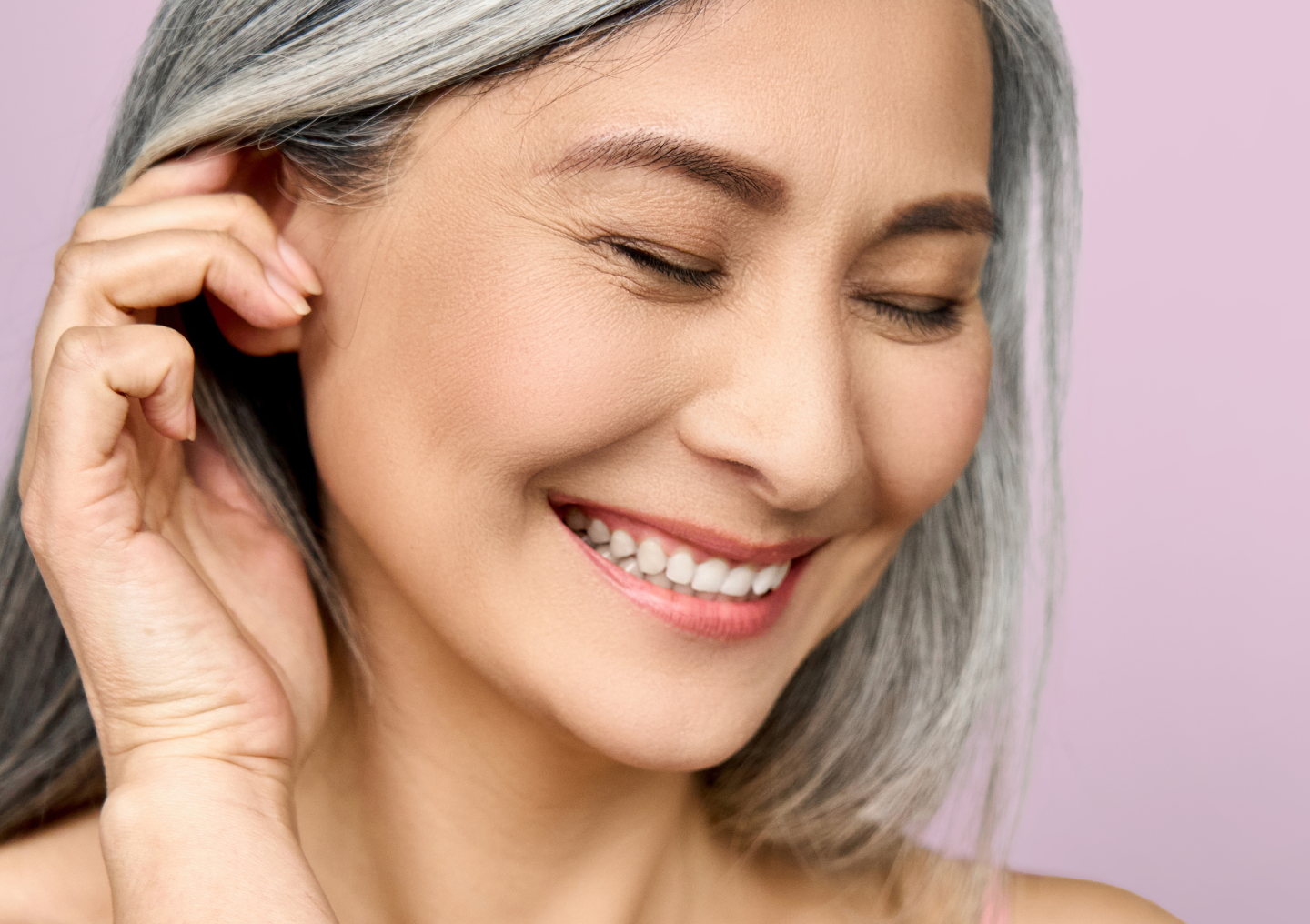 Smiling woman with smooth, radiant skin after Chapter Aesthetic Studio CO2 laser resurfacing, a treatment that reduces wrinkles, sun damage, and uneven texture.