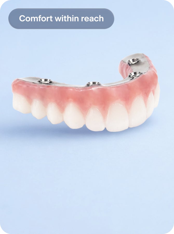 Full-arch dental implant bridge with natural-looking teeth on a light blue background. Text reads “Comfort within reach.” Image shows a fixed implant-supported arch designed for secure fit and everyday comfort.