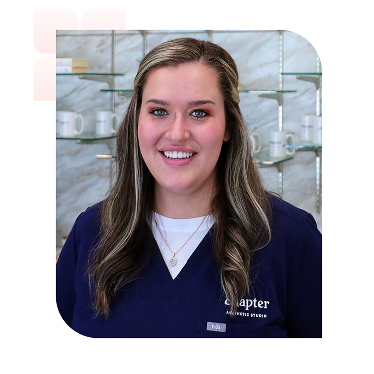 A smiling woman in blue scrubs