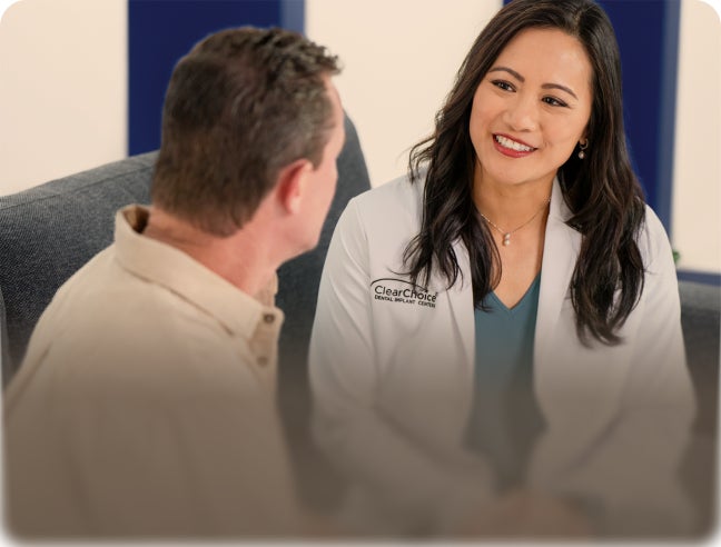 ClearChoice doctor speaking with patient with text “Free consultation – With you at every step” promoting free dental implant consultation.