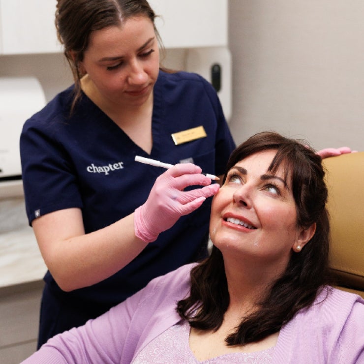 A practitioner administers a facial injection to a patient