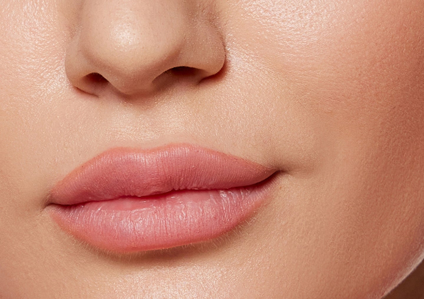 A closeup of a woman's lips after receiving filler treatment at Chapter