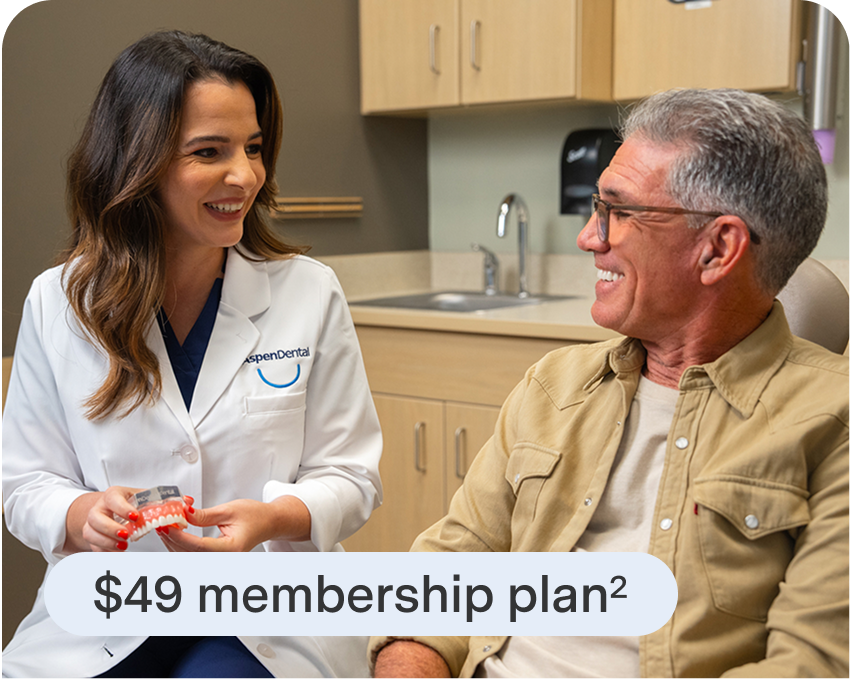 Patient and Aspen Dental professional discuss membership care plan for dental implants, promoting affordability and ongoing support.