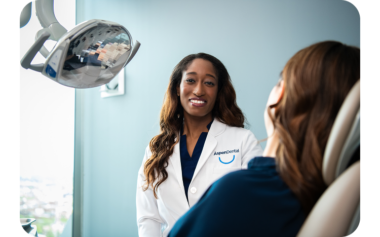 A dental professional consults with a patient