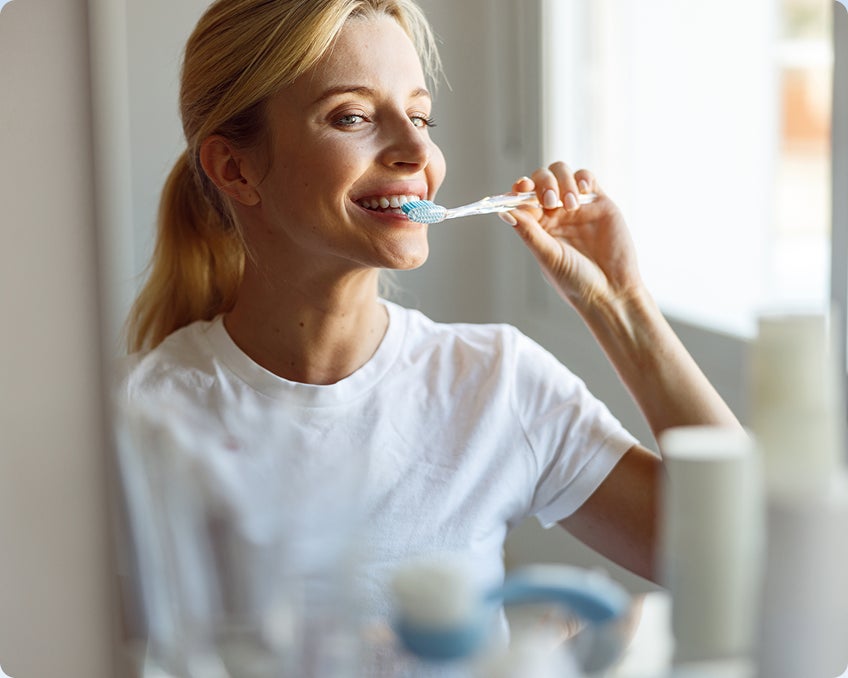 A ClearChoice patient following oral hygiene tips from their dental implants care team to ensure a smooth healing process.