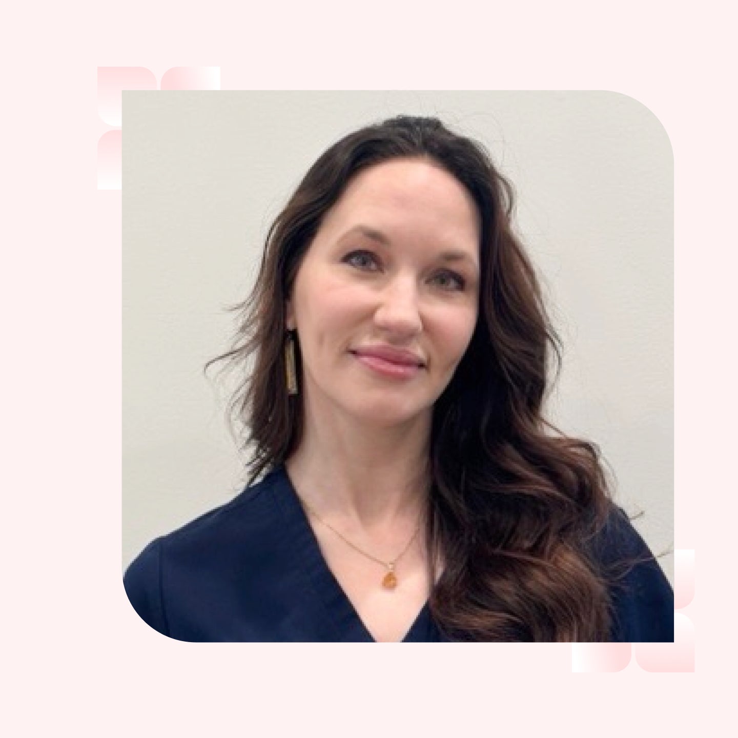 A woman with wavy brown hair smiles