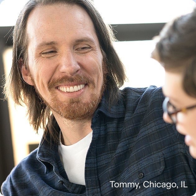 Tommy from Chicago, IL smiling confidently after dental implant treatment, highlighting the life-changing benefits of dental implants for improved comfort, stability, and appearance.