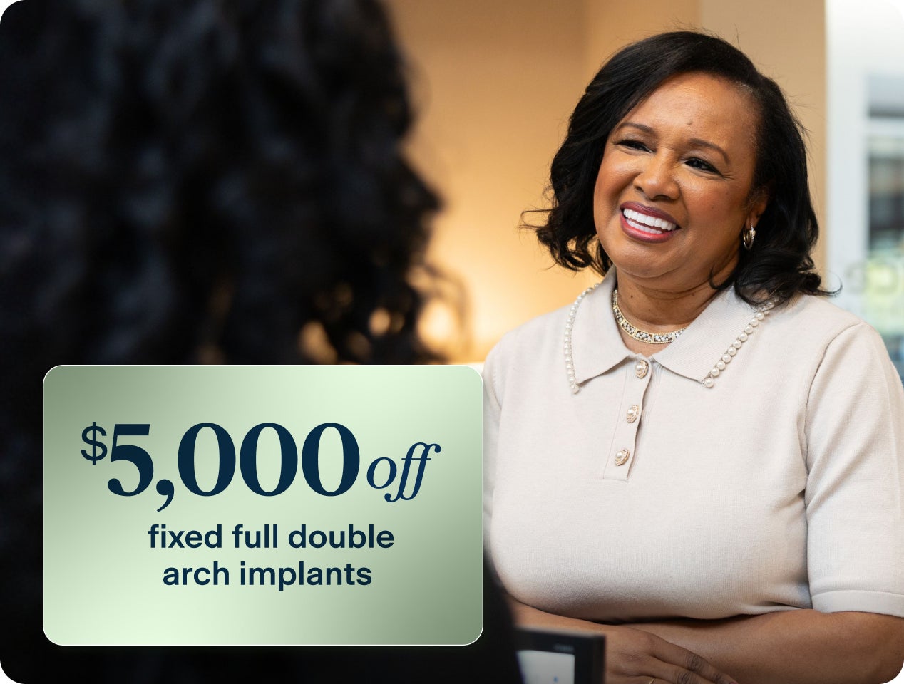 Promotional graphic offering $5,000 off fixed full double arch dental implants when showing a qualifying insurance card.