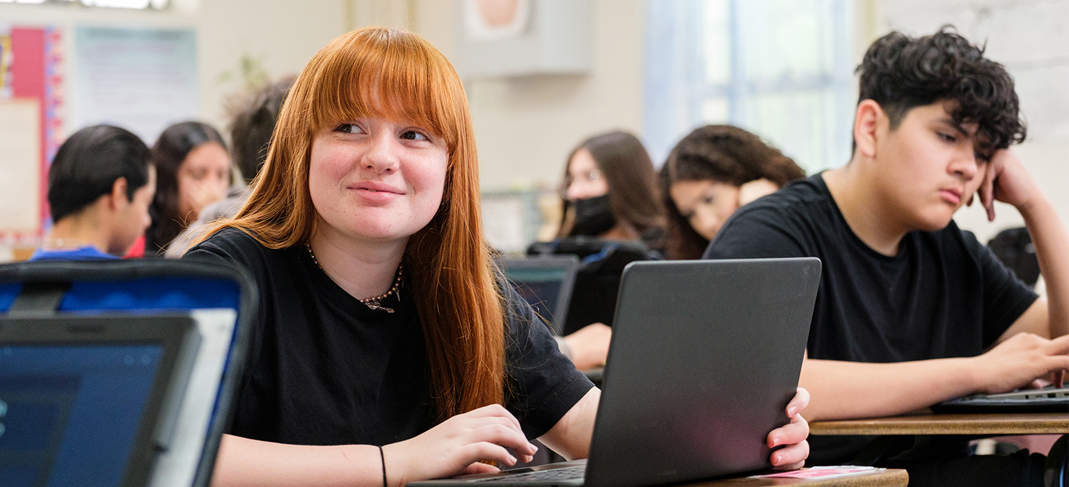 Student works on a laptop.