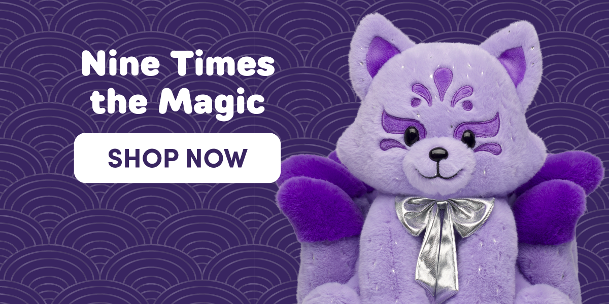 Nine Times the Magic graphic featuring a lavender fox-inspired plush with embroidered purple facial markings, deep purple wings, and a metallic silver bow around its neck. The plush sits against a dark purple patterned background with a repeating wave design. Text reads: Nine Times the Magic and SHOP NOW.