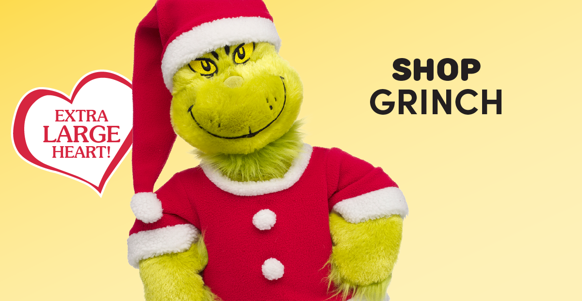Holiday-themed email featuring a family gathered around a book with Build-A-Bear The Grinch plush characters and Max the dog plush beside them. The Grinch logo appears above the headline TIS THE SEASON TO BE GRINCHY, followed by the text Even the grouchiest names on your list will love these Grinch gifts! and a red SHOP NOW button. Below, product sections showcase a Grinch plush in a Santa outfit with the text SHOP GRINCH and an Extra Large Heart badge, Max the dog plush with SHOP MAX, a Giant Grinch plush with an Extra Large Heart badge and SHOP GIANT GRINCH, and a teddy bear wearing Grinch-print pajamas with SHOP GRINCHY FASHIONS. A red
 SHOP COLLECTION button appears at the bottom.