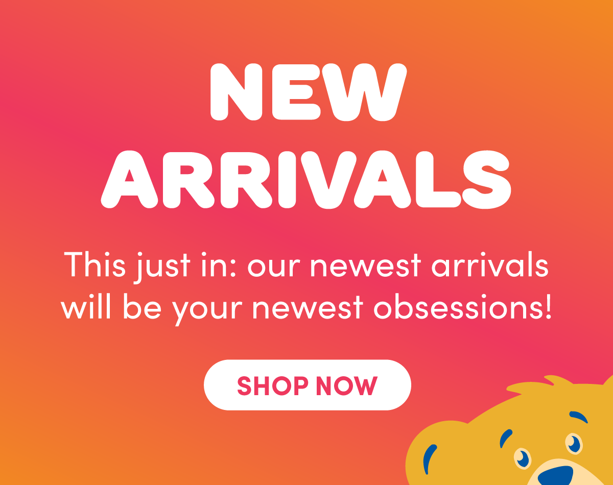 NEW ARRIVALS graphic with an orange-to-pink gradient background and a partial Build-A-Bear teddy bear peeking up from the bottom right corner. Text reads: NEW ARRIVALS, This just in: our newest arrivals will be your newest obsessions!, and SHOP NOW.