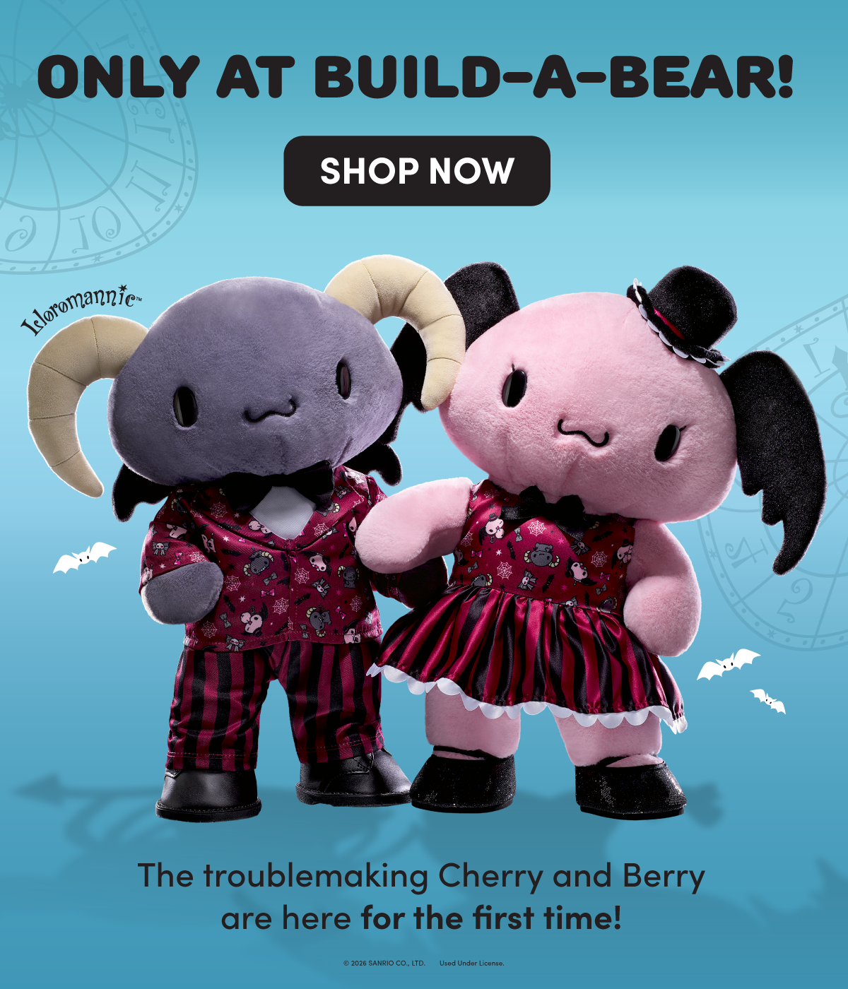 Lloromannic™ graphic featuring the mischievous twins Berry and Cherry dressed in matching Halloween-inspired outfits. Berry, a gray plush with curled ram horns, small black bat wings, a black bow tie, patterned shirt, red-and-black striped pants, and black shoes, stands beside Cherry, a pink plush with black floppy ears, a small black top hat, a matching patterned dress, striped skirt, and black shoes. Small white bats and subtle clockwork designs decorate the blue background. Text reads: ONLY AT BUILD-A-BEAR!, SHOP NOW, and The troublemaking Cherry and Berry are here for the first time!