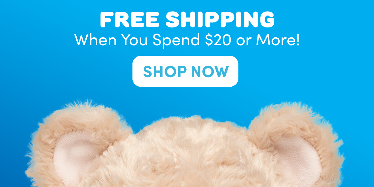FREE SHIPPING promotional graphic with a bright blue background and the top of a tan teddy bear peeking up from the bottom edge of the image. A white call-to-action button appears beneath the offer text. Text reads: FREE SHIPPING, When You Spend $20 or More!, and SHOP NOW.