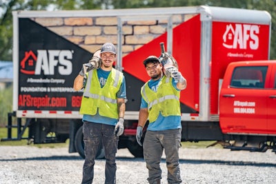 AFS crew standing by a company truck
