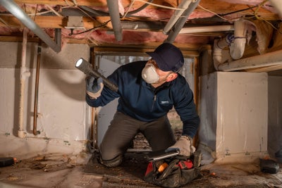 Tar Heel Basement Systems inspector looking at crawl space insulation