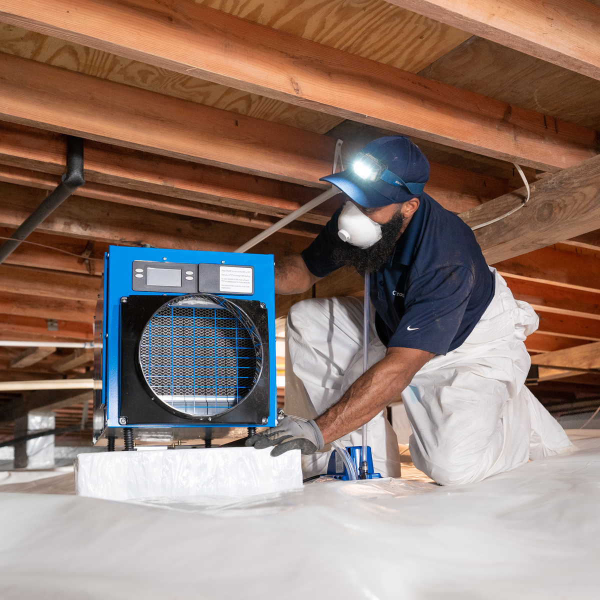 A Groundworks worker installed a dehumidifier in a crawl space.