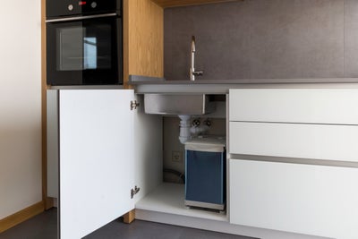 Open cabinet door under a sink