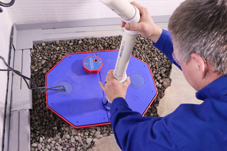 A Groundworks worker installing a sump pump.