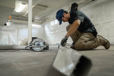 a groundworks professional preparing an interior drain for installation