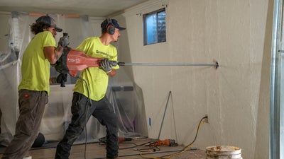 Groundworks crew installing wall anchors