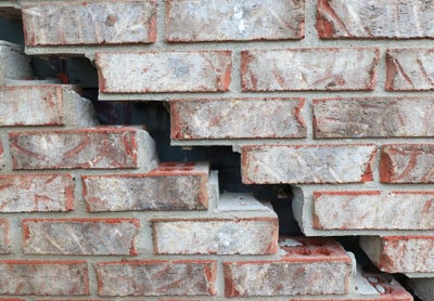 Close up of a bricks that are separating on brick wall in need of major repair