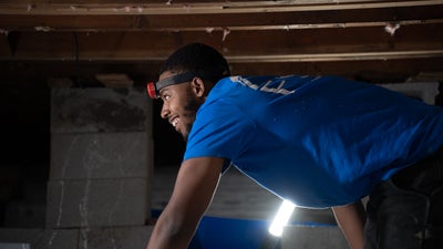 FSM installer working inside a crawl space.
