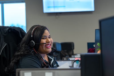 smiling call center representative on the phone