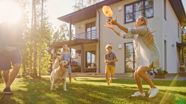 family playing frisbee outside