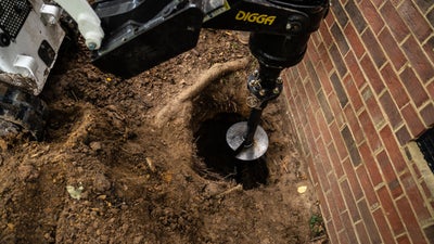 Large machinery repairing a foundation to prevent drywall nail pops.