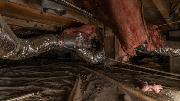 failing fiberglass insulation in a nasty crawl space