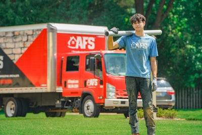 AFS crewman posing with tool.