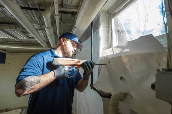 Groundwork tech installing basement windows