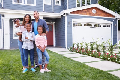 Family in front of their new home