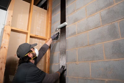 A worker installing SettleStop Carbon Fiber System.
