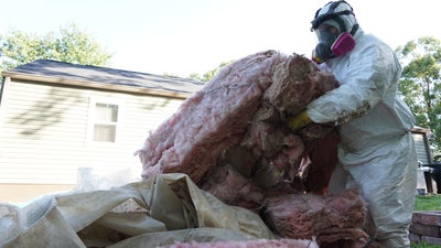 Removal of old crawl space insulation.