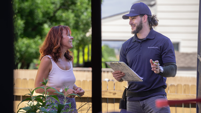 Ground Works man is being welcomed by happy homeowner outside