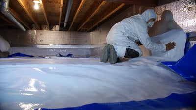 crew insulating and encapsulating a crawl space