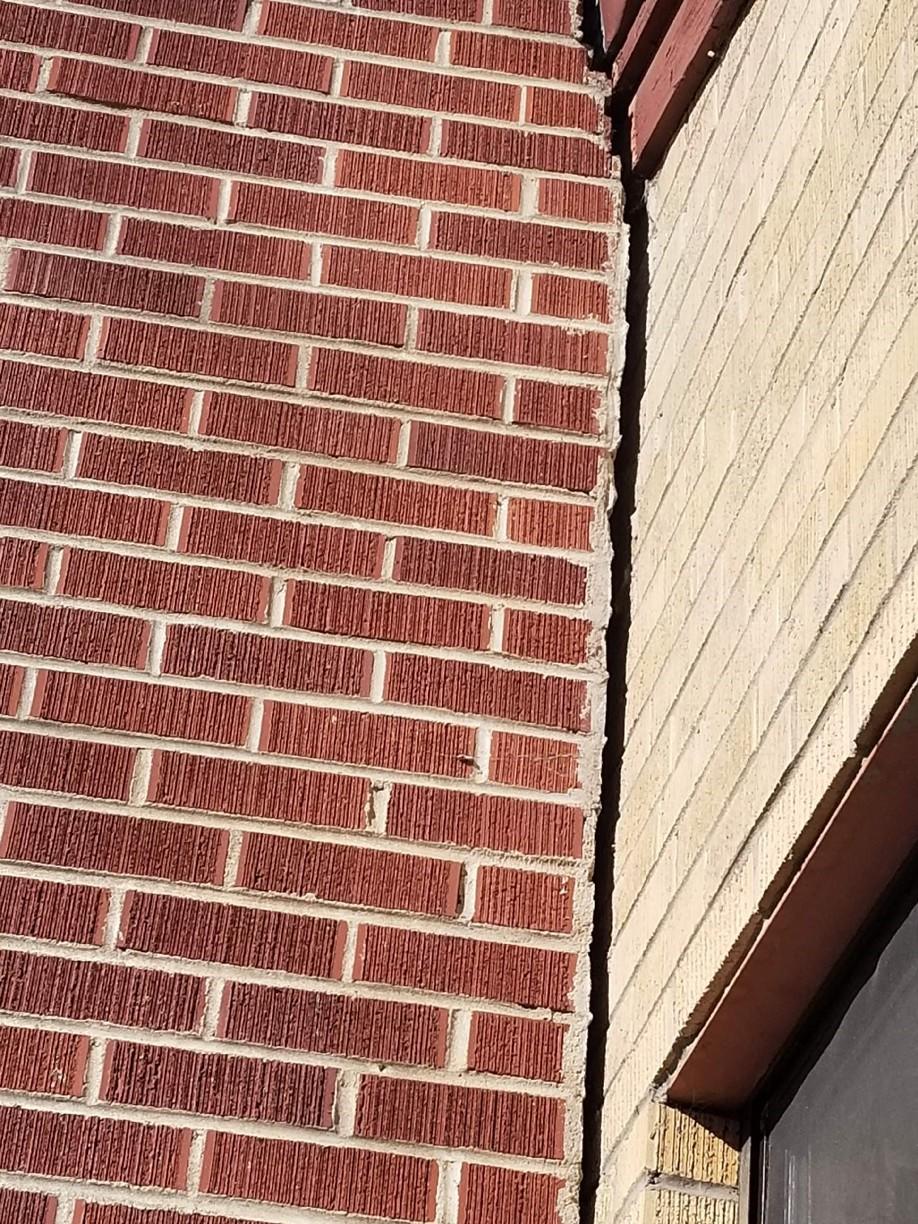 Close up of a brick cracked chimney. 